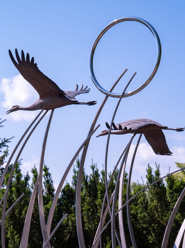 Metal Birds 'flying' among metal grass.