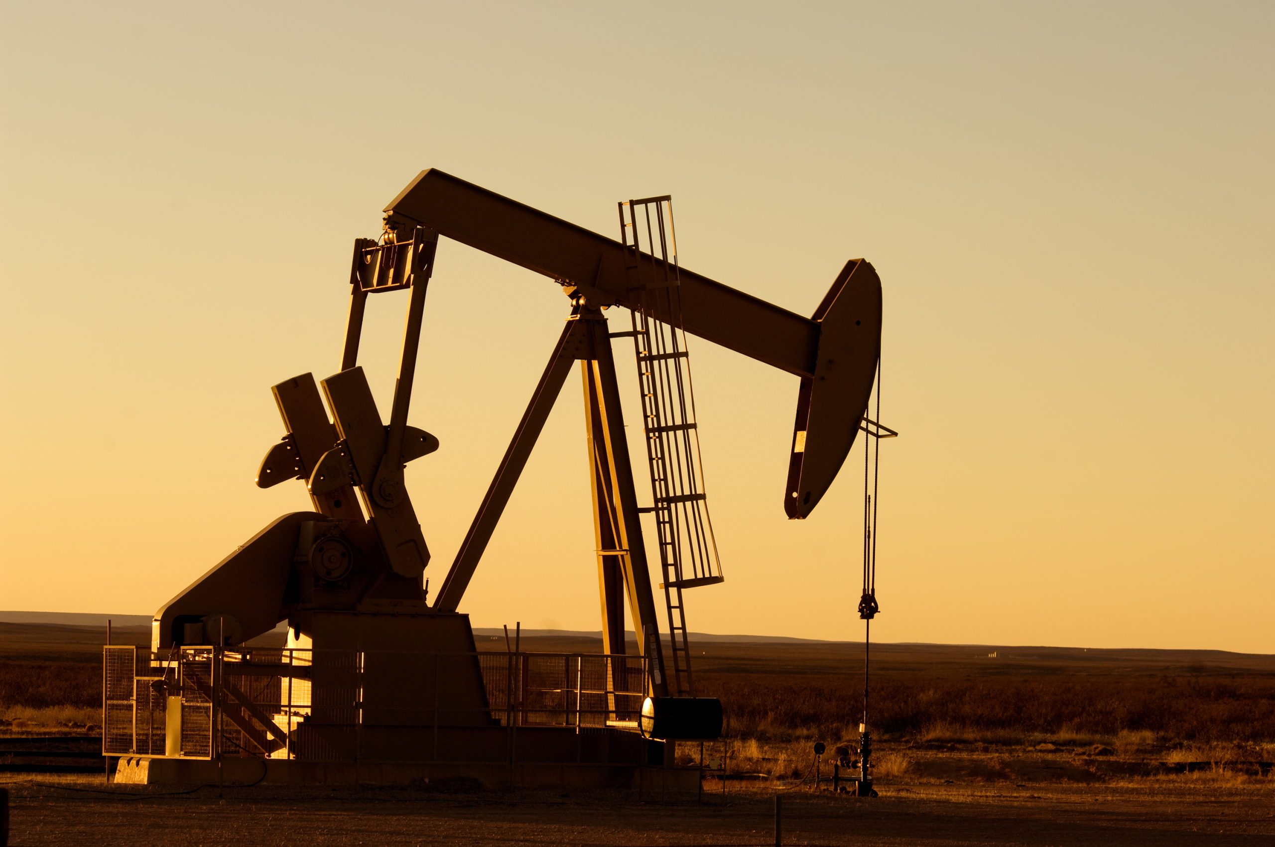 Working oil pump in rural Texas at sunset.