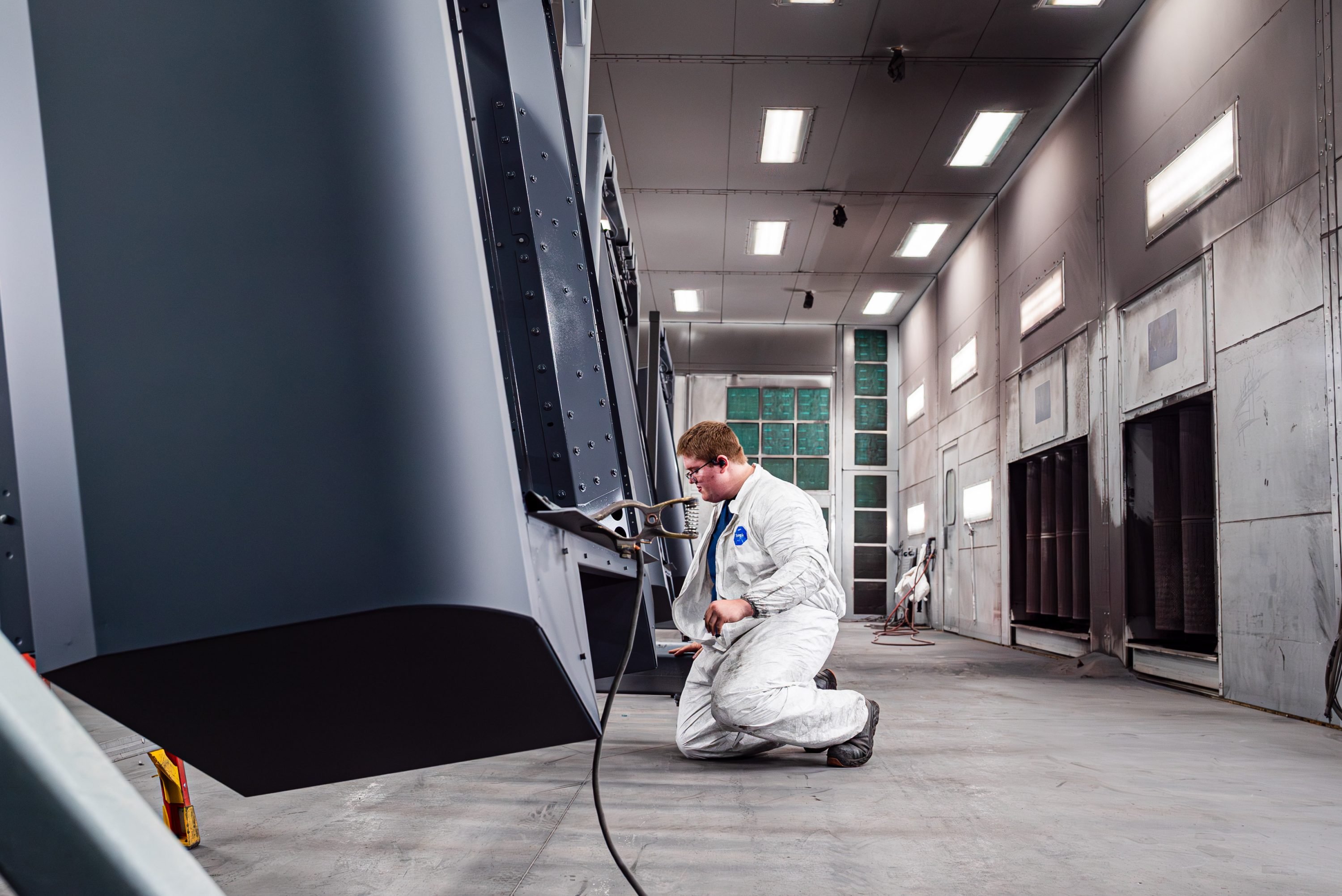 TMCO employee in the large project paint bay.