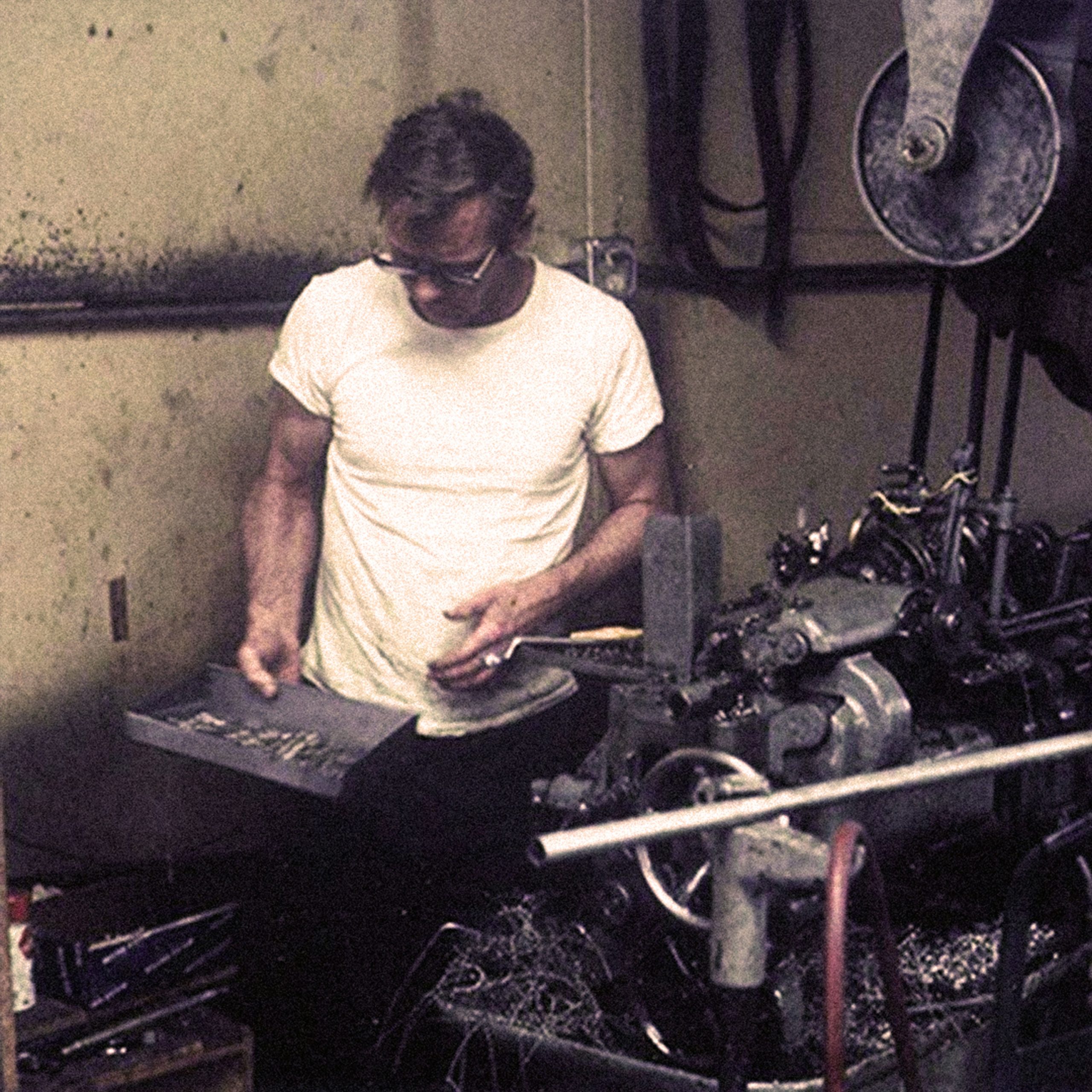 Younger Chairman Roland Temme working in a metal workshop.