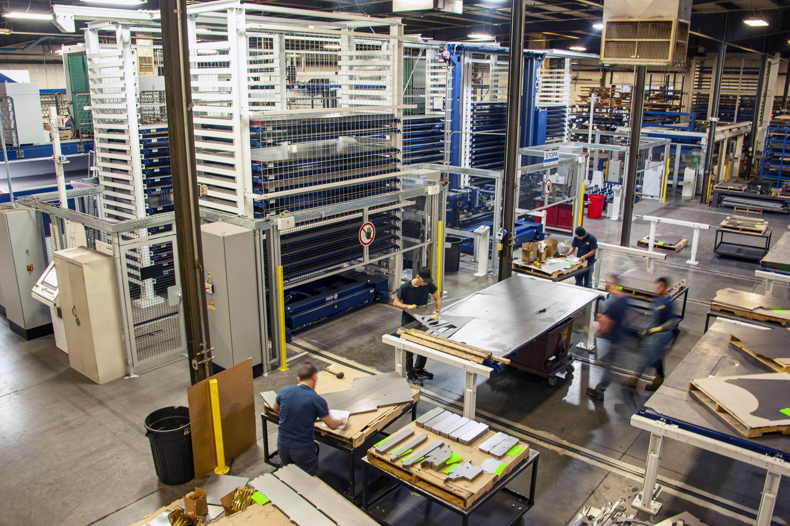 TMCO warehouse and workshop with employees and machinery.